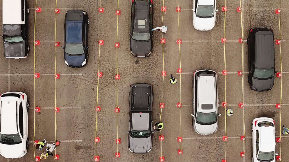 PHOTO: This aerial view shows people waiting in line in their cars at a COVID-19 testing site at Dodger Stadium in Los Angeles, California, on Nov. 18, 2020.