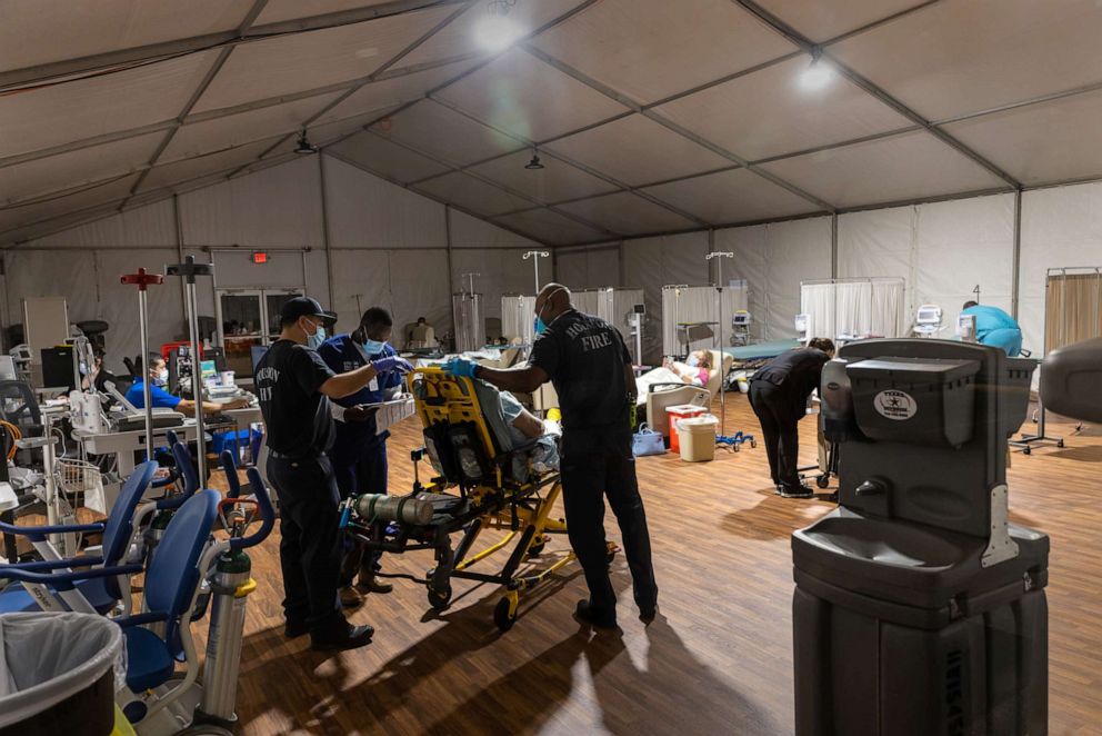 PHOTO: Houston Fire Department EMS medics deliver a woman with possible COVID-19 symptoms to a COVID-19 overflow area at Memorial Herman Northeast Hospital on Aug. 19, 2021, in Houston.