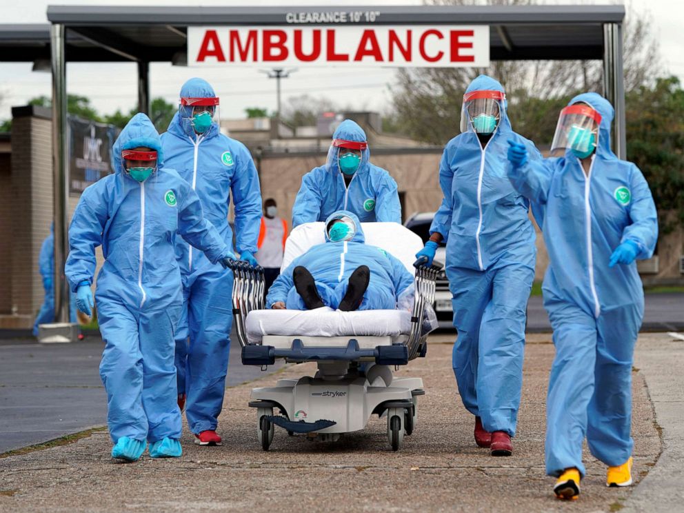 PHOTO: A person is taken on a stretcher into the United Memorial Medical Center after going through testing for COVID-19, March 19, 2020, in Houston.