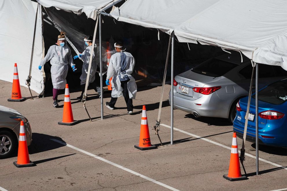 PHOTO: Medical workers provide free Covid-19 tests at a state run drive-thru testing site on the University of Texas El Paso campus in El Paso, Texas, Nov. 14, 2020.