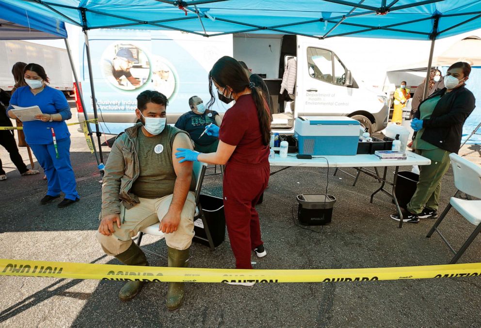 PHOTO: Eustaquio Becerra gets a Pfizer vaccine shot as the Vernon Health Department staff used the city's new mobile health unit clinic to administer COVID-19 vaccinations to nearly 250 essential food processing workers in Vernon, Calif., March 17, 2021.