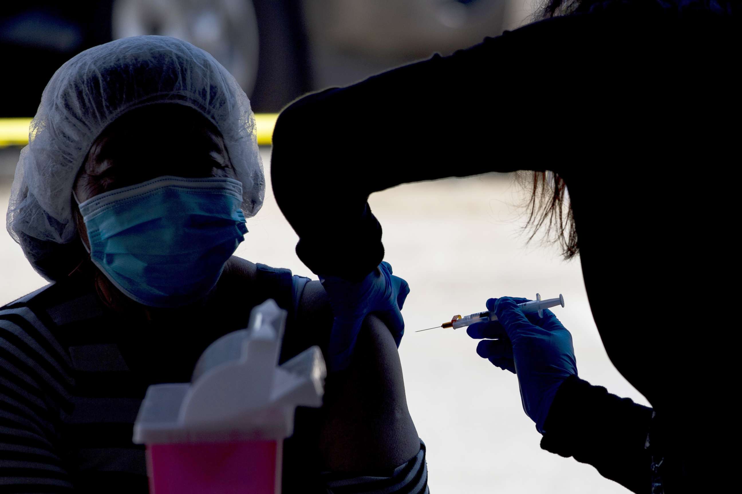 PHOTO: A healthcare worker administers a dose of the Moderna Covid-19 vaccine in Gilroy, Calif., March 4, 2021. 