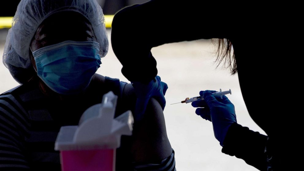 PHOTO: A healthcare worker administers a dose of the Moderna Covid-19 vaccine in Gilroy, Calif., March 4, 2021. 