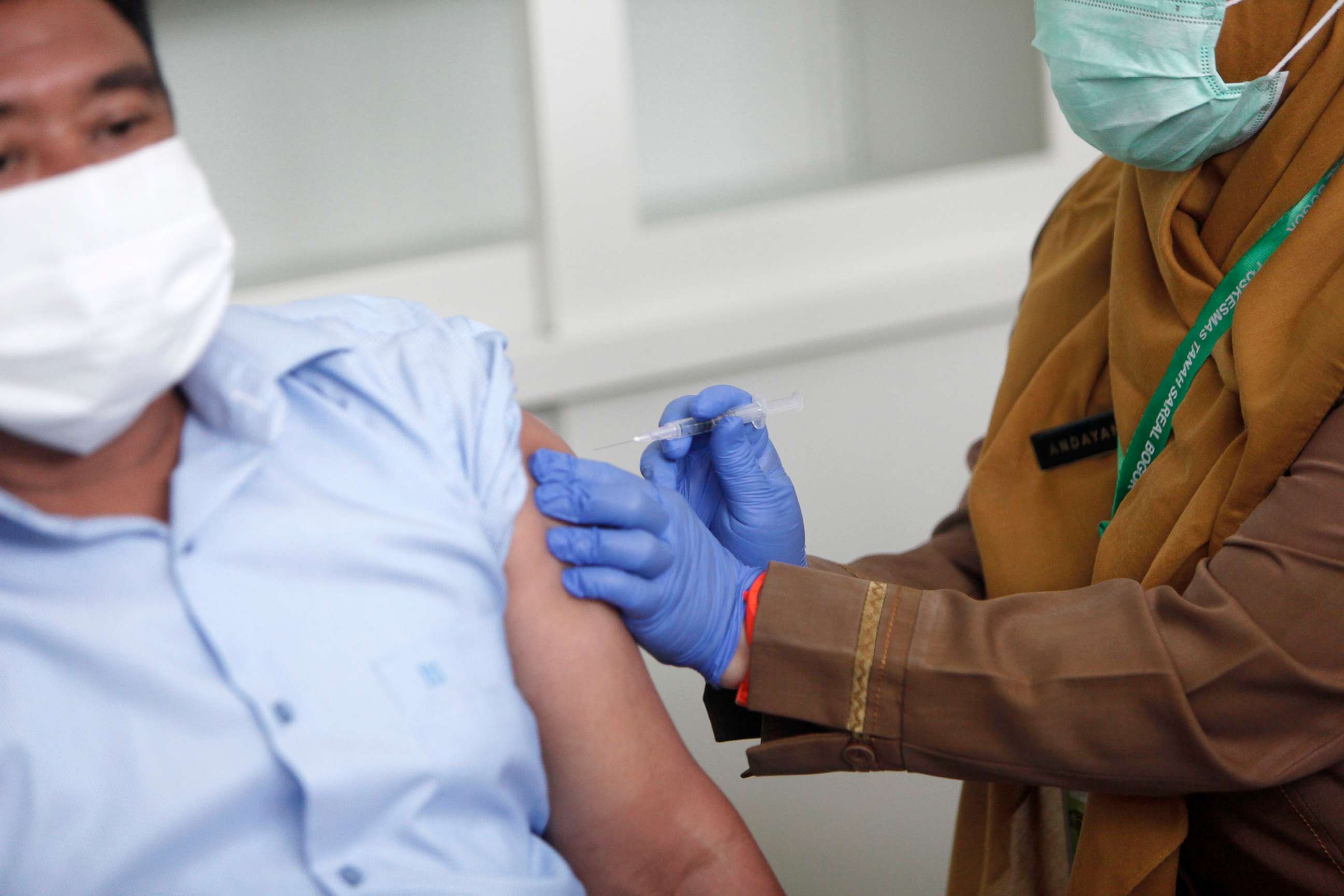 PHOTO: A Covid-19 vaccine is administered during a trial at the Tanah Sareal Health Center, Bogor, Indonesia, on Oct. 4 ,2020.