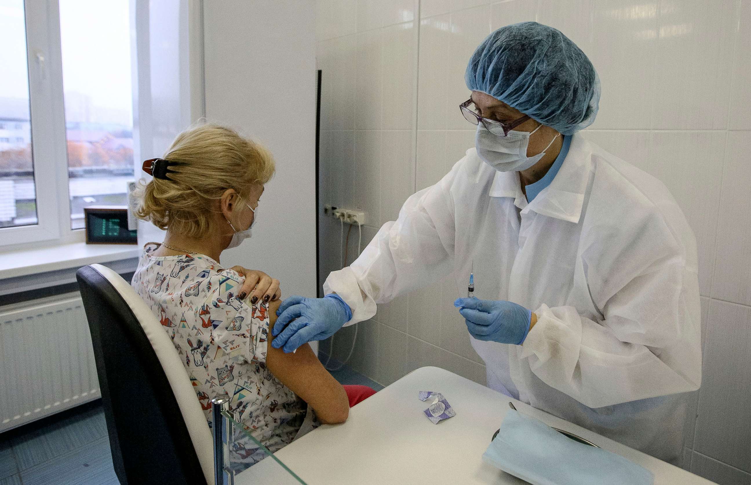 PHOTO:  An employee of the Murmansk Regional Clinical Hospital is inoculated with Russia's coronavirus vaccine in Murmansk, Russia, May 10, 2020.