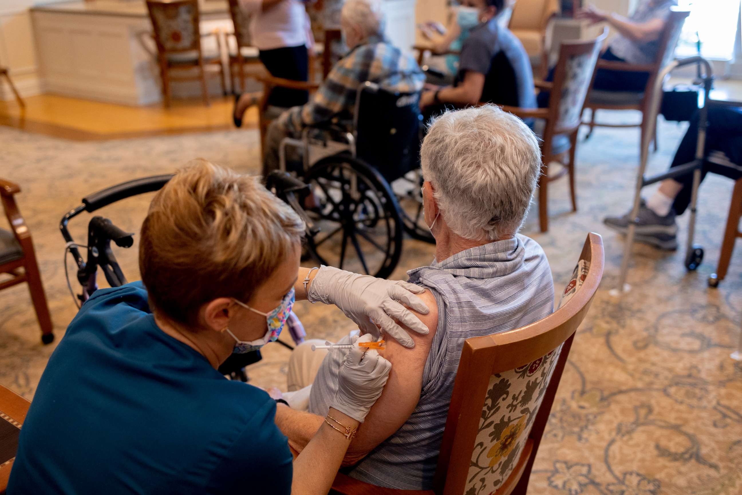 PHOTO: In this Aug. 25, 2012, file photo, a healthcare worker administers a third dose of the Pfizer-BioNTech COVID-19 vaccine at a senior living facility in Worcester, Penn.