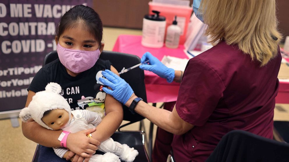 PHOTO: In this Nov. 12, 2021, file photo, a first grade student receives a COVID-19 vaccine at Arturo Velasquez Institute in Chicago.