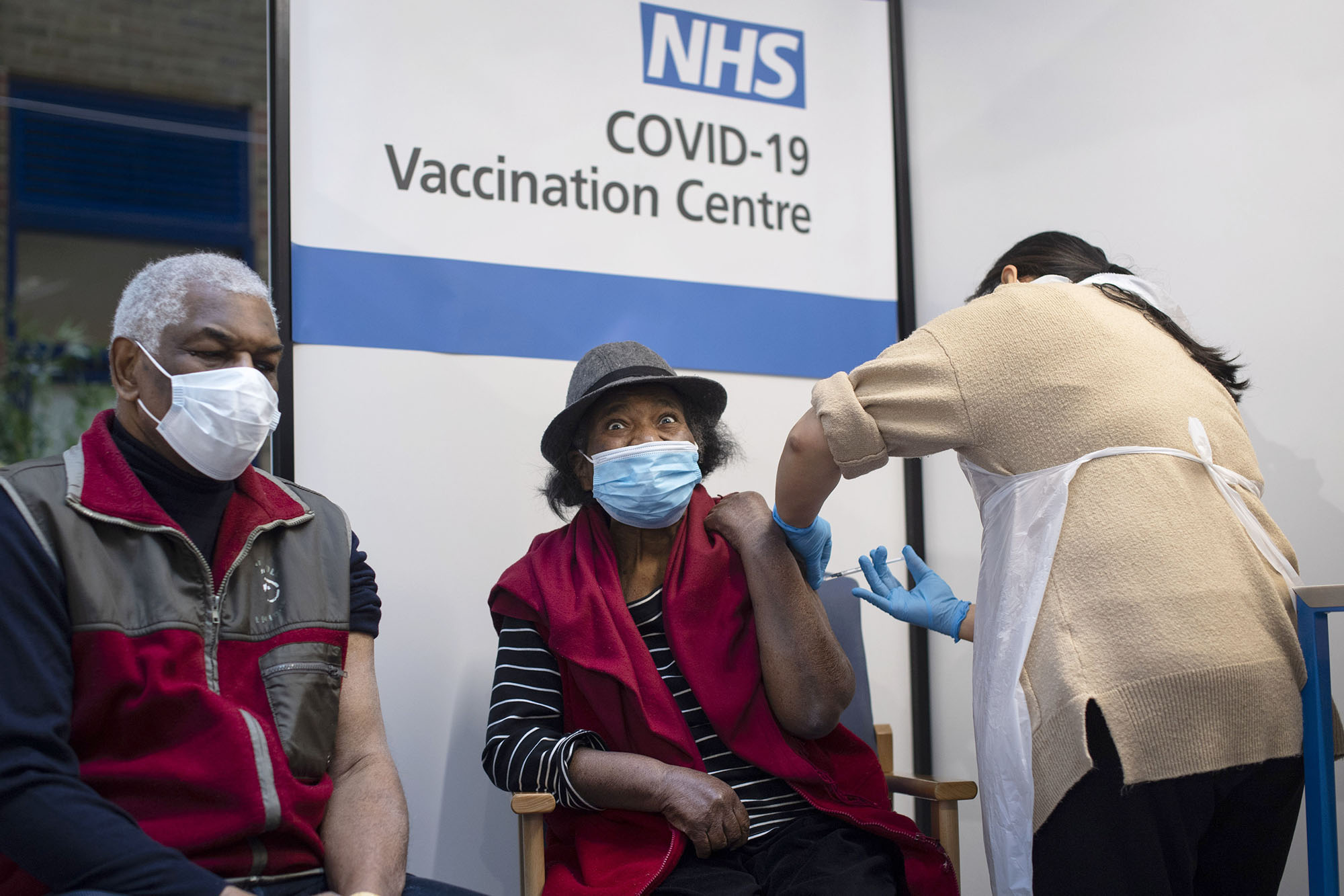 PHOTO:Lorna Lucas, 81, reacts as she receives the first of two Pfizer/BioNTech COVID-19 vaccine jabs shortly before her husband, Winston also has one administered in central London on Dec. 8, 2020.