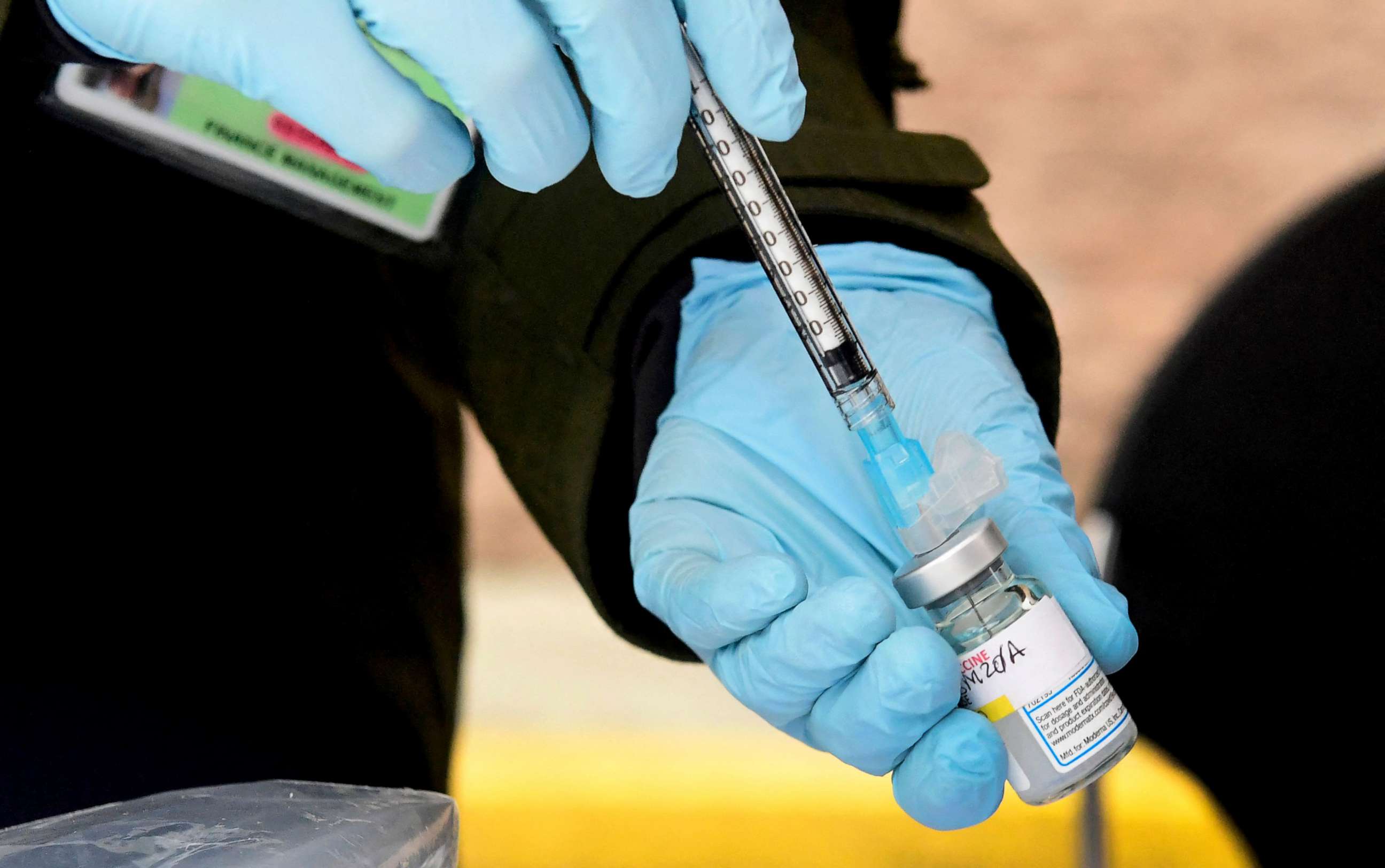 PHOTO: A registered nurse loads the Moderna Covid-19 vaccine into a syringe ahead of the distribution of vaccines in downtown Los Angeles.