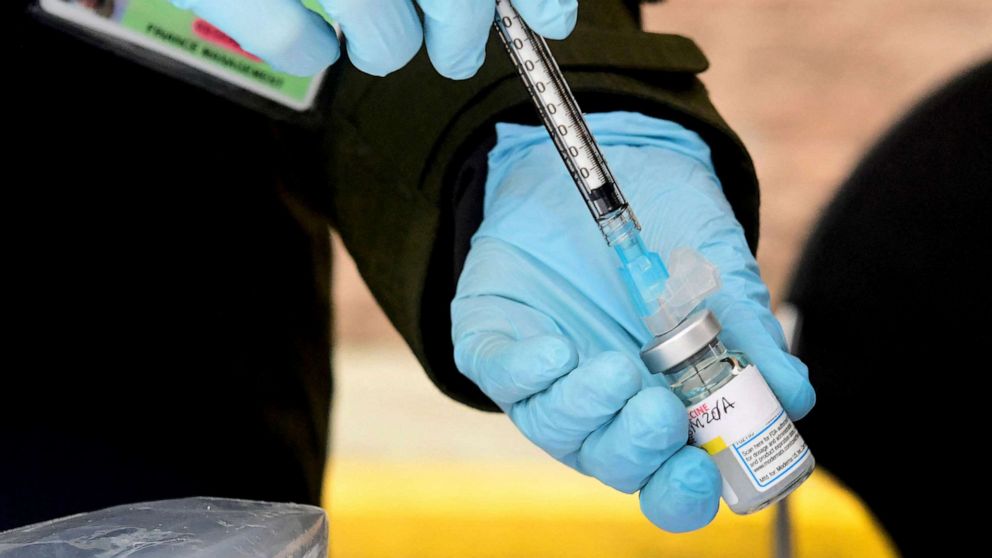 PHOTO: A registered nurse loads the Moderna Covid-19 vaccine into a syringe ahead of the distribution of vaccines in downtown Los Angeles.