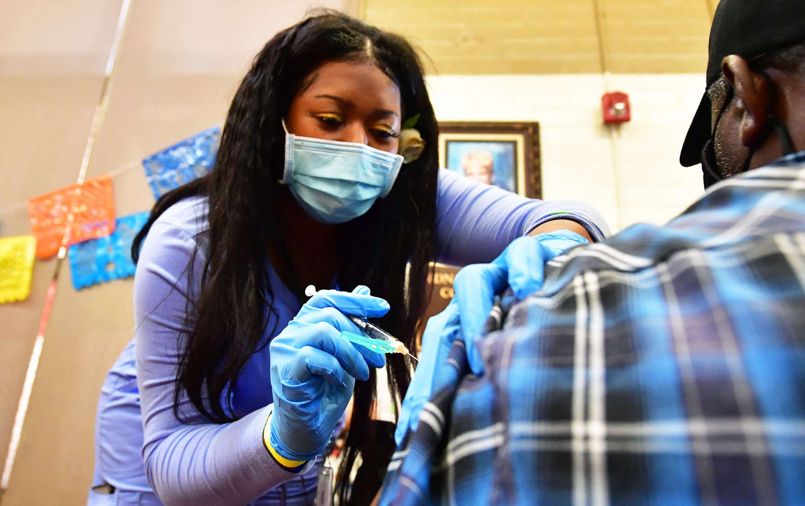 PHOTO: A nurse administers the Pfizer booster shot at a COVID-19 vaccination and testing site in Los Angeles, on May 5, 2022.