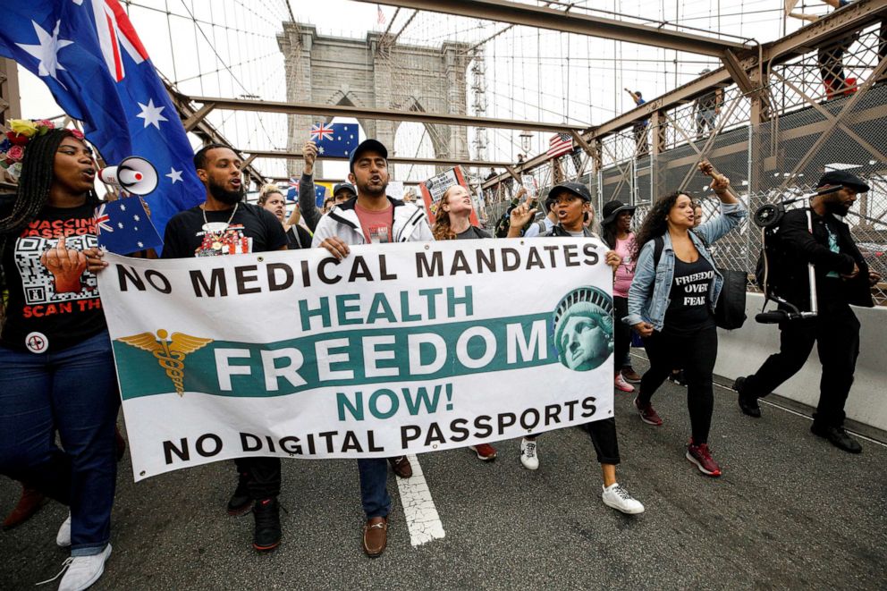 PHOTO: Protestors demonstrate against the mandate that teachers and staff in the New York City Schools system be vaccinated against the coronavirus disease on the Brooklyn Bridge in New York, Oct. 4, 2021.