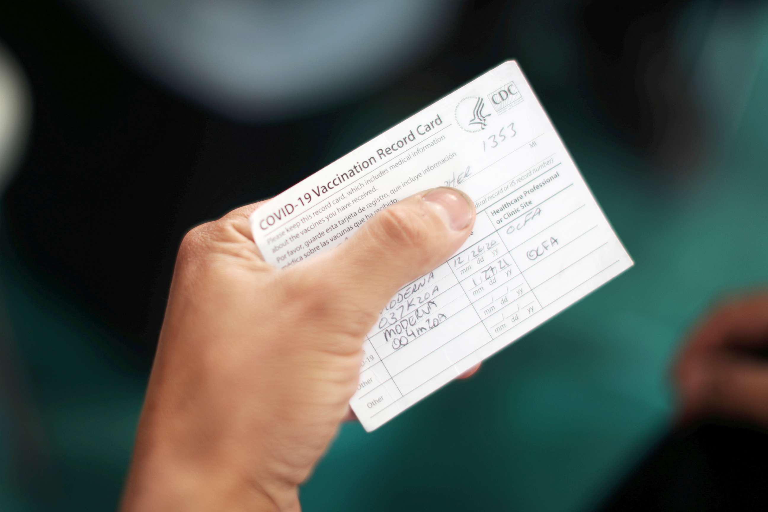 PHOTO: An Orange County firefighter holds his vaccination card after receiving the coronavirus disease vaccine in Irvine, Calif., Jan. 27, 2021.