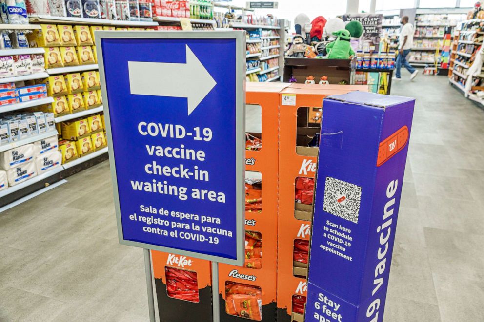 PHOTO: In this Oct. 12, 2021, file photo, a bilingual Covid-19 vaccine check-in waiting area sign is shown at a Walgreens in Miami Beach, Fla.