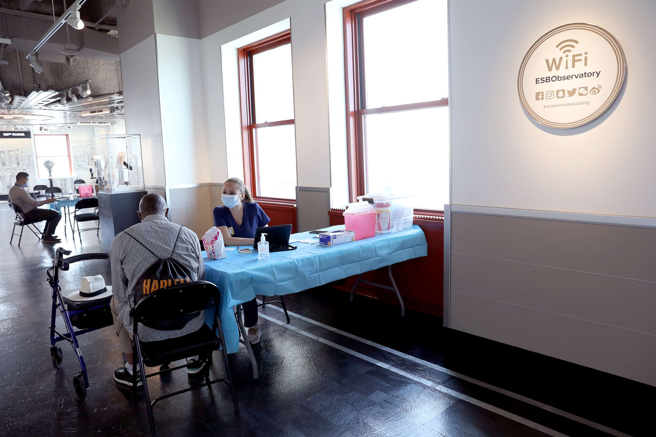 PHOTO: A healthcare worker speaks with a patient as the Empire State Building Observatory offers COVID-19 vaccines at The Empire State Building on June 18, 2021, in New York.