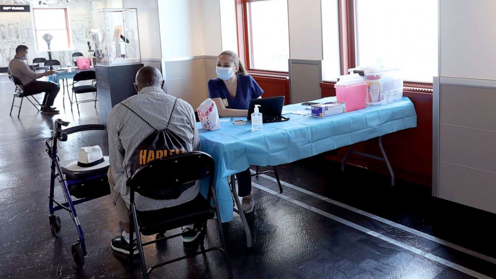 PHOTO: A healthcare worker speaks with a patient as the Empire State Building Observatory offers COVID-19 vaccines at The Empire State Building on June 18, 2021, in New York.