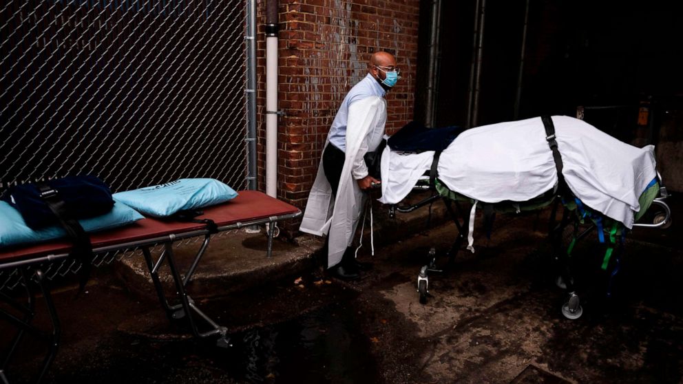 PHOTO: Maryland Cremation Services transporter Reggie Elliott brings the remains of a COVID-19 victim to his van from the hospital's morgue in Baltimore, Maryland, on Dec. 24, 2020.