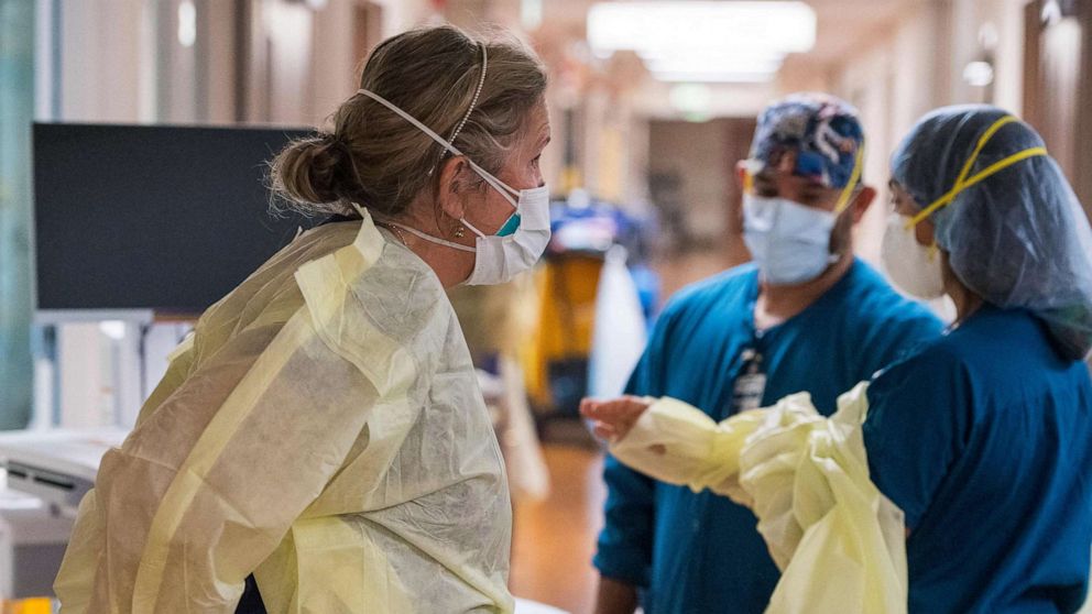 PHOTO: Registered nurse Katie Katie (L) and other nurses, put on personal protective equipment before tending to a Covid-19 patient inside the intensive care unit) at Adventist Health in Sonora, Calif., Aug. 27, 2021.