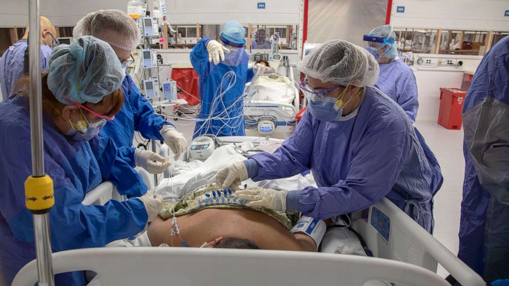PHOTO: Staff prepare a patient for transport from the old ICU to the Shell Space ICU in Teaneck, N.J., April 2, 2020.