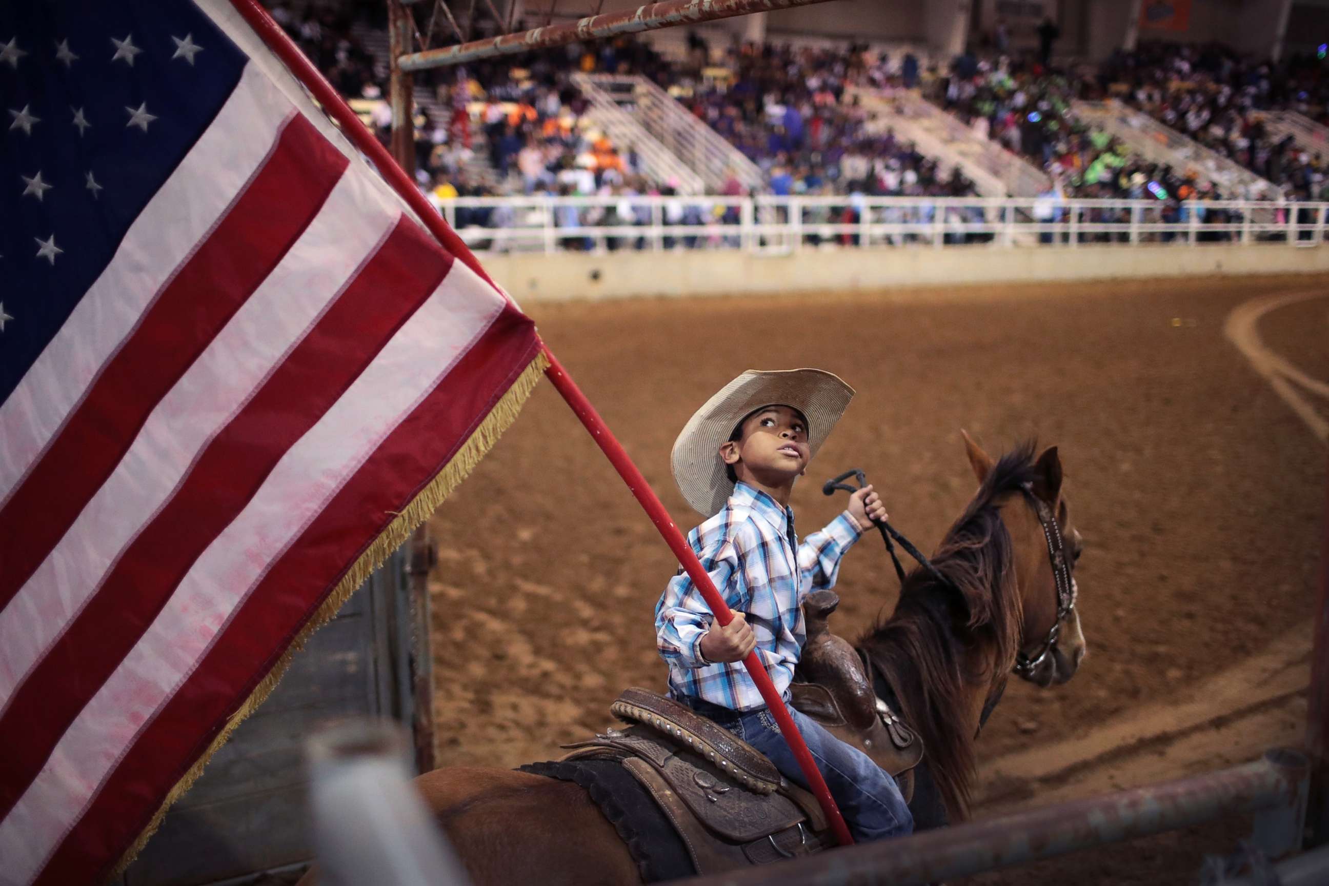 PHOTO: Lindon Demery carries the flag into the arena before the start of competition at the Bill Pickett Invitational Rodeo on March 31, 2017 in Memphis, Tenn.