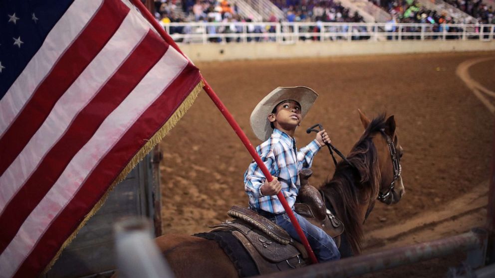 PHOTO: Lindon Demery carries the flag into the arena before the start of competition at the Bill Pickett Invitational Rodeo on March 31, 2017 in Memphis, Tenn.
