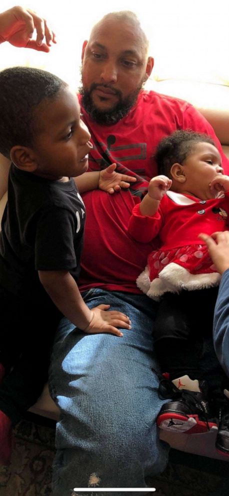 PHOTO: Craig Brewer relaxes in this undated photo his 2-year-old son and 11-month-old daughter on his lap. Brewer, 41, was shot to death on April 7, 2019, at a Waffle House in Gainesville, Fla., after offering to buy meals for customers.