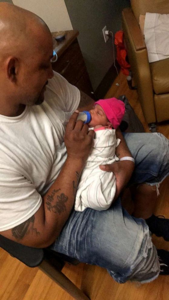 PHOTO: Craig Brewer, 41, feeds his daughter shortly after her birth in May 2018. Brewer, 41, was shot to death on April 7, 2019, at a Waffle House in Gainesville, Fla., after offering to buy meals for customers.