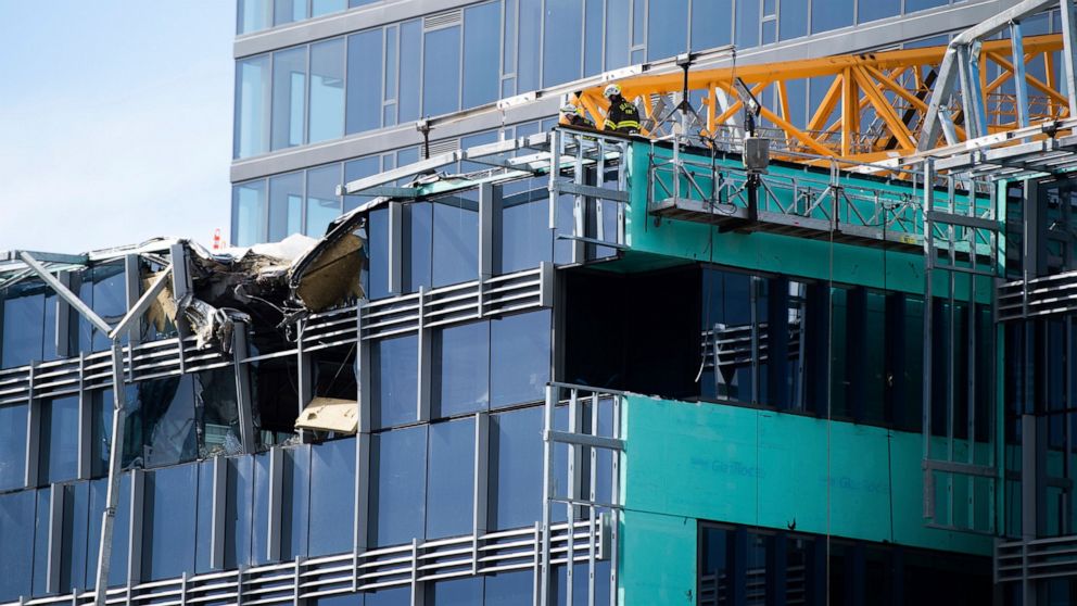 PHOTO: Emergency crews work the scene of a construction crane collapse near the intersection of Mercer Street and Fairview Avenue near Interstate 5 in Seattle, on Saturday, April 27, 2019.