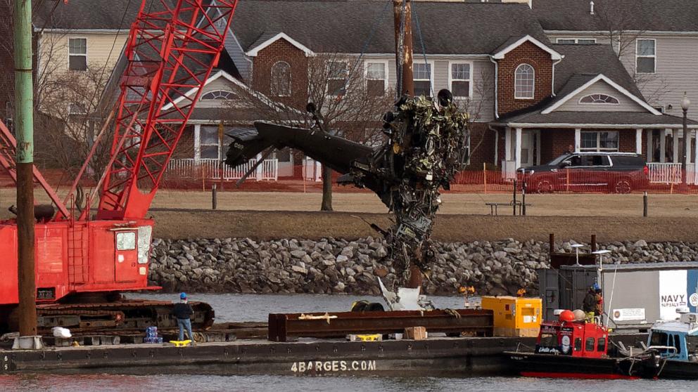 PHOTO: Rescue and salvage crews pull up a part of a Army Black Hawk helicopter that collided midair with an American Airlines jet, at a wreckage site in the Potomac River from Ronald Reagan Washington National Airport, Feb. 6, 2025, in Arlington, Va. 