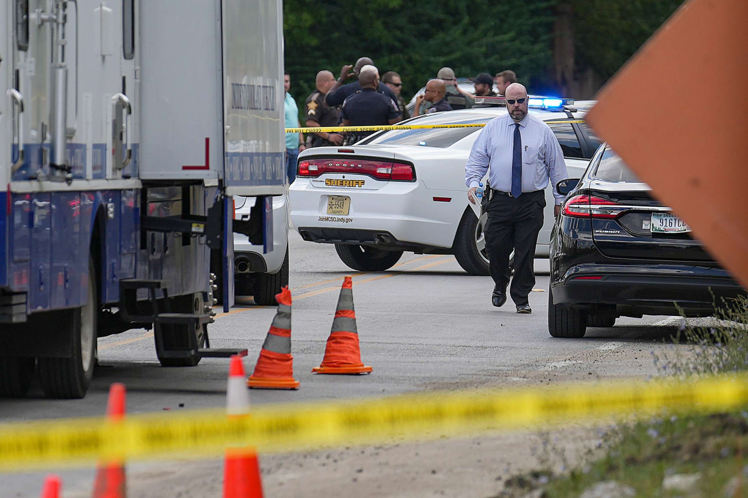 PHOTO: Officers and detectives gather at the scene where a suspect crashed a jail wagon after stealing it, July 10, 2023, just outside the Community Justice Campus in Indianapolis.
