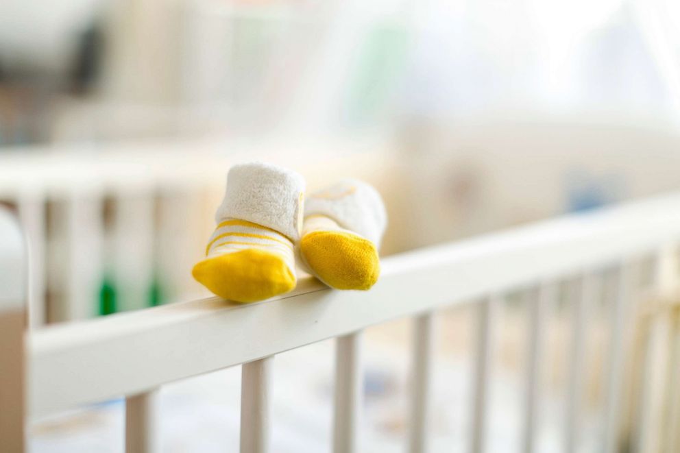 PHOTO: Baby booties are pictured on the edge of a crib in this undated stock photo.