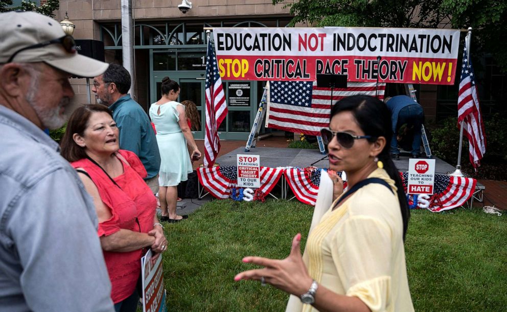 PHOTO: In this June 12, 2021, file photo, people talk before the start of a rally against "critical race theory" (CRT) being taught in schools at the Loudoun County Government center in Leesburg, Va.