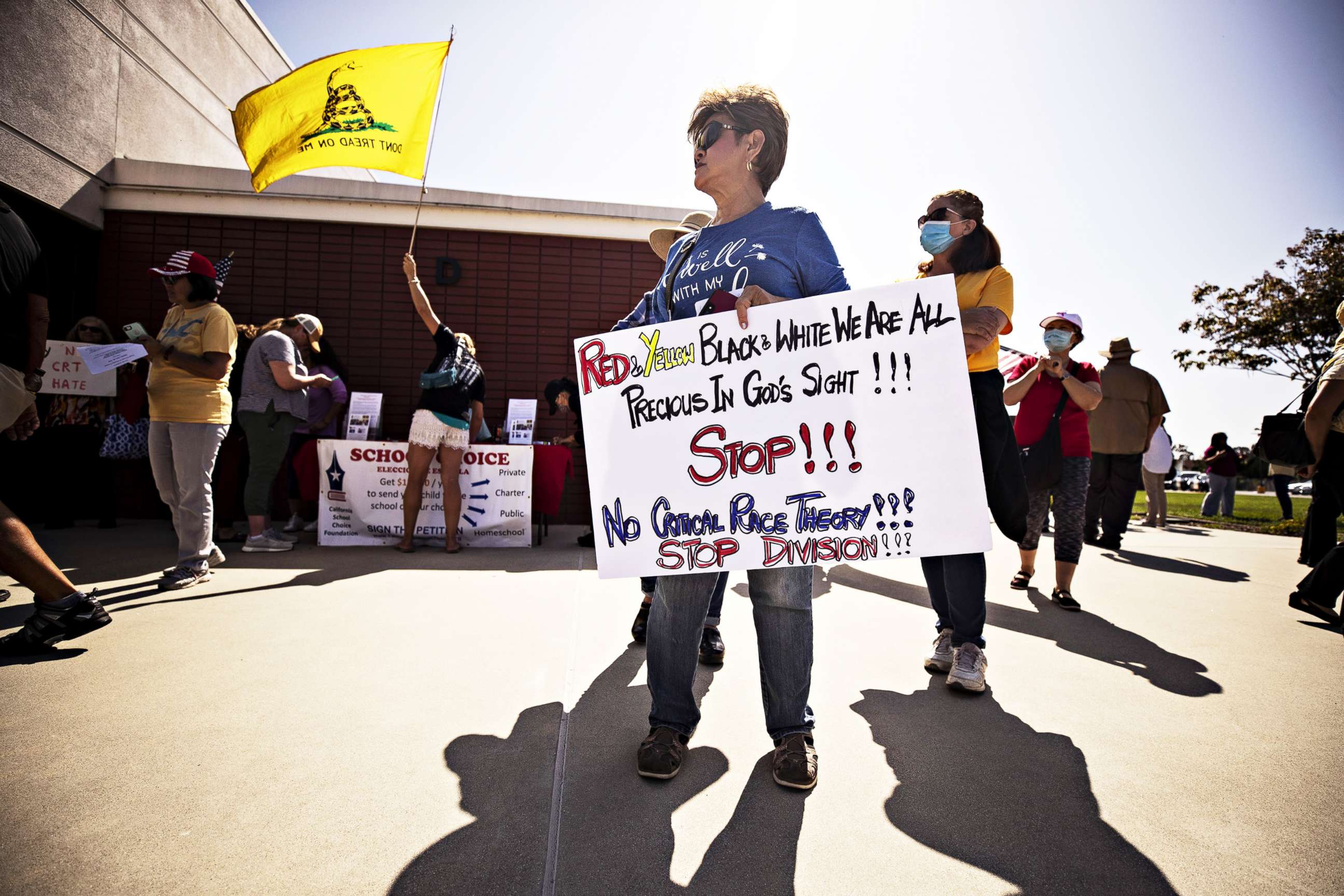 PHOTO: A protester holds a sign reading 'Red and Yellow Black and White We are all Precious in God's Sight! Stop! No Critical Race Theory! Stop Division!' at the Los Alamitos Unified School District building in Los Alamitos, Calif., May 11, 2021.