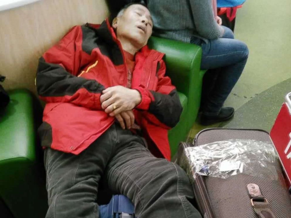 PHOTO: Yuanjun Cui, who has stage 4 cancer, lies on luggage after U.S. Customs and Border Protection issued his deportation on May 21, 2018.