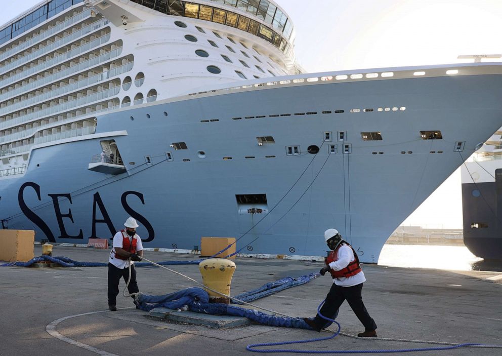 PHOTO: Dock workers use ropes to tie Royal Caribbean's Odyssey of the Seas to its berthing spot at Port Everglades on June 10, 2021, in Fort Lauderdale, Fla.