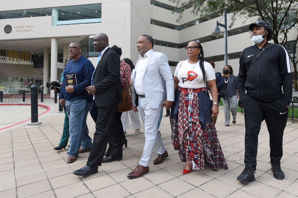 PHOTO: Attorney Ben Crump, second from left, walks with Ron Lacks, left, Alfred Lacks Carter, third from left, both grandsons of Henrietta Lacks, and other descendants, outside the federal courthouse in Baltimore, Oct. 4, 2021.