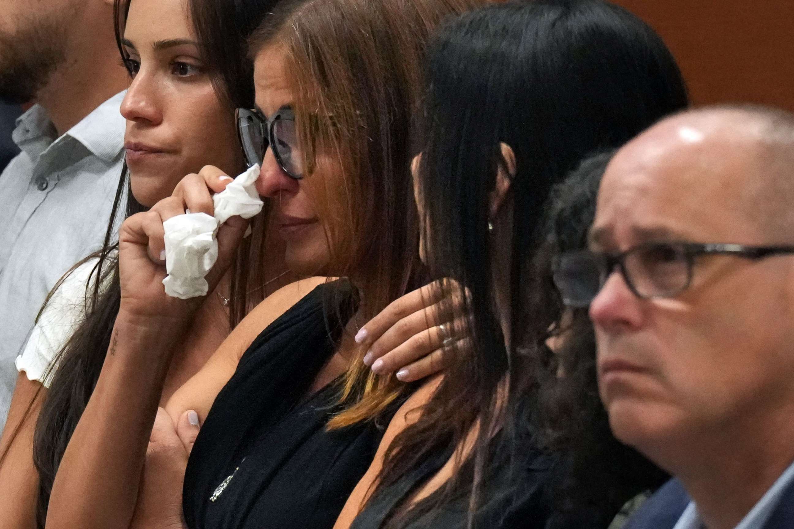 Patricia Padauy Oliver is comforted as a witness testifies to her son's fatal injuries during the penalty phase of the trial of Marjory Stoneman Douglas High School shooter Nikolas Cruz, in Fort Lauderdale, Fla., Aug. 1, 2022.