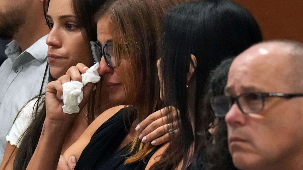 Patricia Padauy Oliver is comforted as a witness testifies to her son's fatal injuries during the penalty phase of the trial of Marjory Stoneman Douglas High School shooter Nikolas Cruz, in Fort Lauderdale, Fla., Aug. 1, 2022.