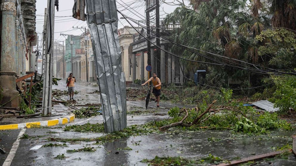 PHOTO: Fallen electricity lines, metal and tree branches litter a street after Hurricane Ian hit Pinar del Rio, Cuba, Sept. 27, 2022.