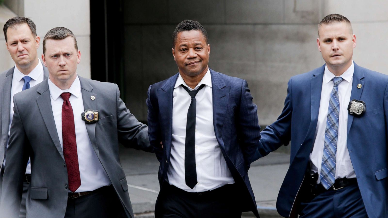 PHOTO:Cuba Gooding Jr. is escorted handcuffed by NYPD officers as he exits the New York City Police Department's Special Victims Division (SVU) in New York, June 13, 2019.