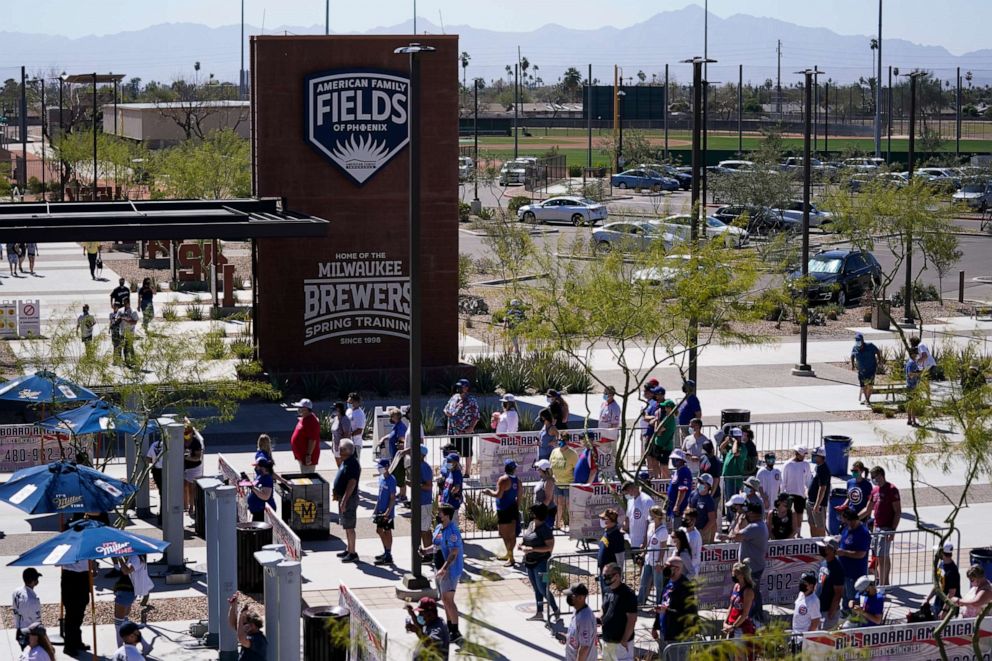 PHOTO: Fans enter American Family Fields ballpark before a spring training baseball game between the Milwaukee Brewers and the Chicago Cubs Saturday, March 6, 2021, in Phoenix.