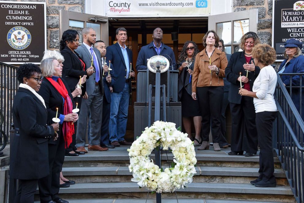 PHOTO: Howard County Executive Calvin Ball, center, leads a moment of silence in honor of the late U.S. Rep. Elijah Cummings, D-Md., Friday, Oct. 18, 2019, outside the congressman's office in Ellicott City, Md. 