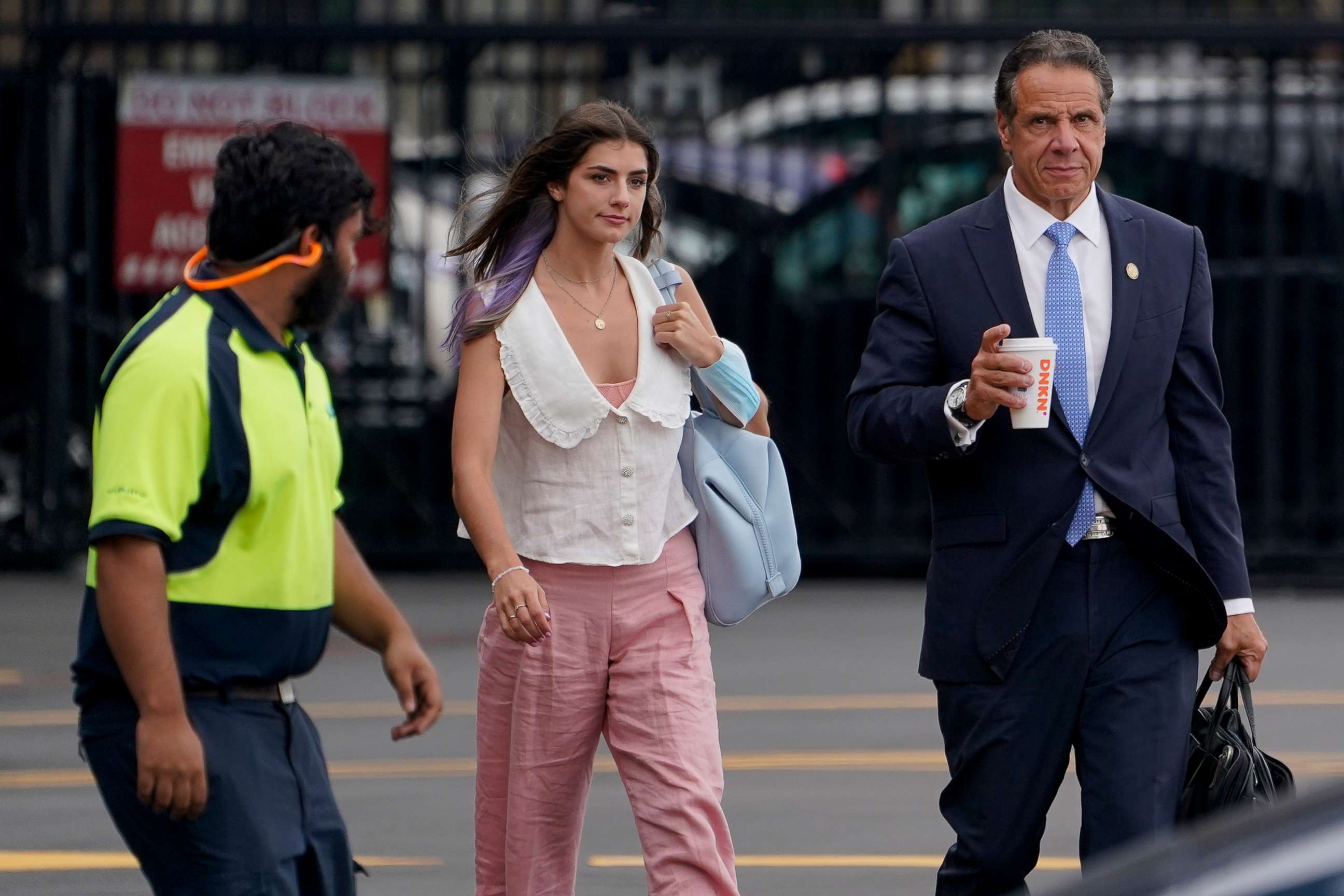 PHOTO: New York Gov. Andrew Cuomo, right, prepares to board a helicopter with his daughter Michaela Cuomo after announcing his resignation, Aug. 10, 2021, in New York.