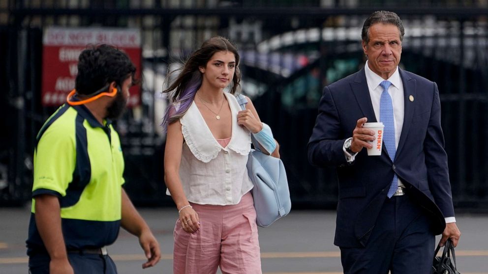 PHOTO: New York Gov. Andrew Cuomo, right, prepares to board a helicopter with his daughter Michaela Cuomo after announcing his resignation, Aug. 10, 2021, in New York.