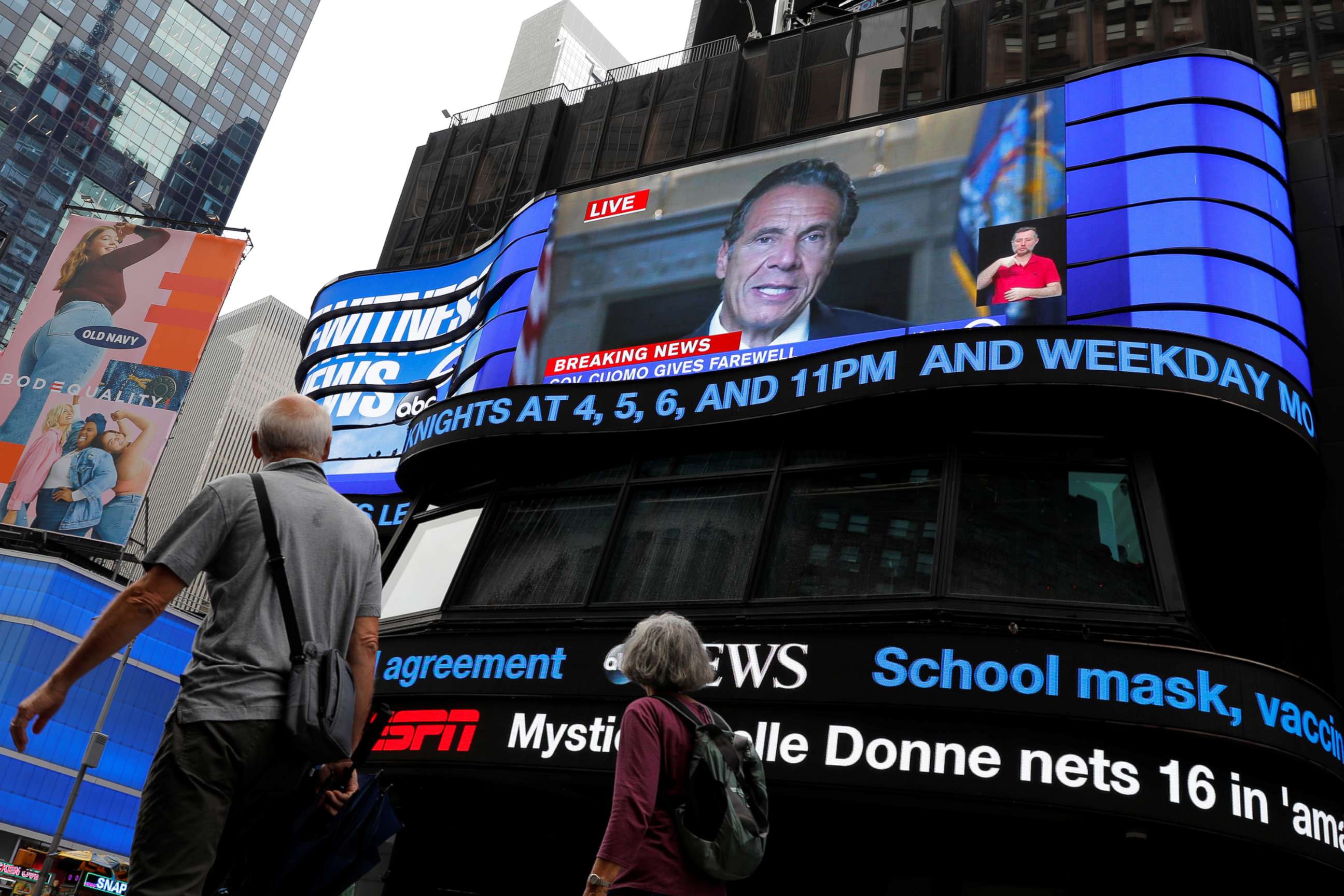 PHOTO: People walk by as a farewell speech by New York Governor Andrew Cuomo is broadcast live on a screen in Times Square on his final day in office in New York City, Aug. 23, 20201.