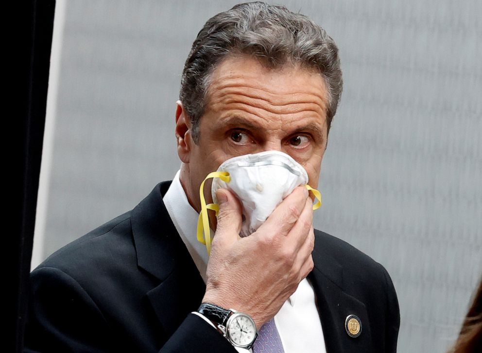 PHOTO: New York Governor Andrew Cuomo holds a protective mask to his face as he arrives for a daily briefing at New York Medical College during the outbreak of the coronavirus disease (COVID-19) in Valhalla, New York, May 7, 2020.