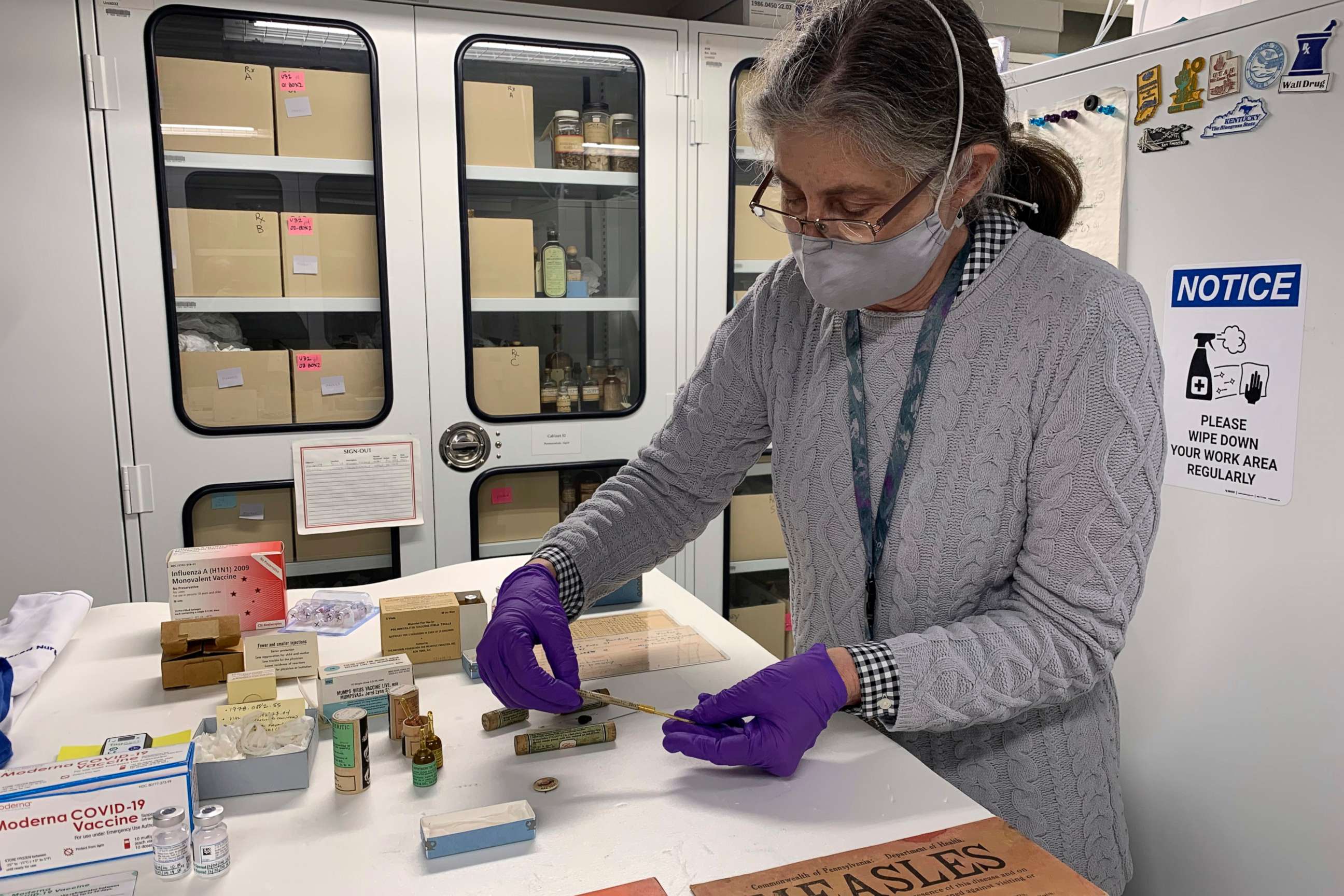 PHOTO: Diane Wendt, a curator at the Smithsonian Institution's National Museum of American History, displays a small glass tube containing one of the original batches of polio vaccine in Washington, D.C., on March 8, 2021.