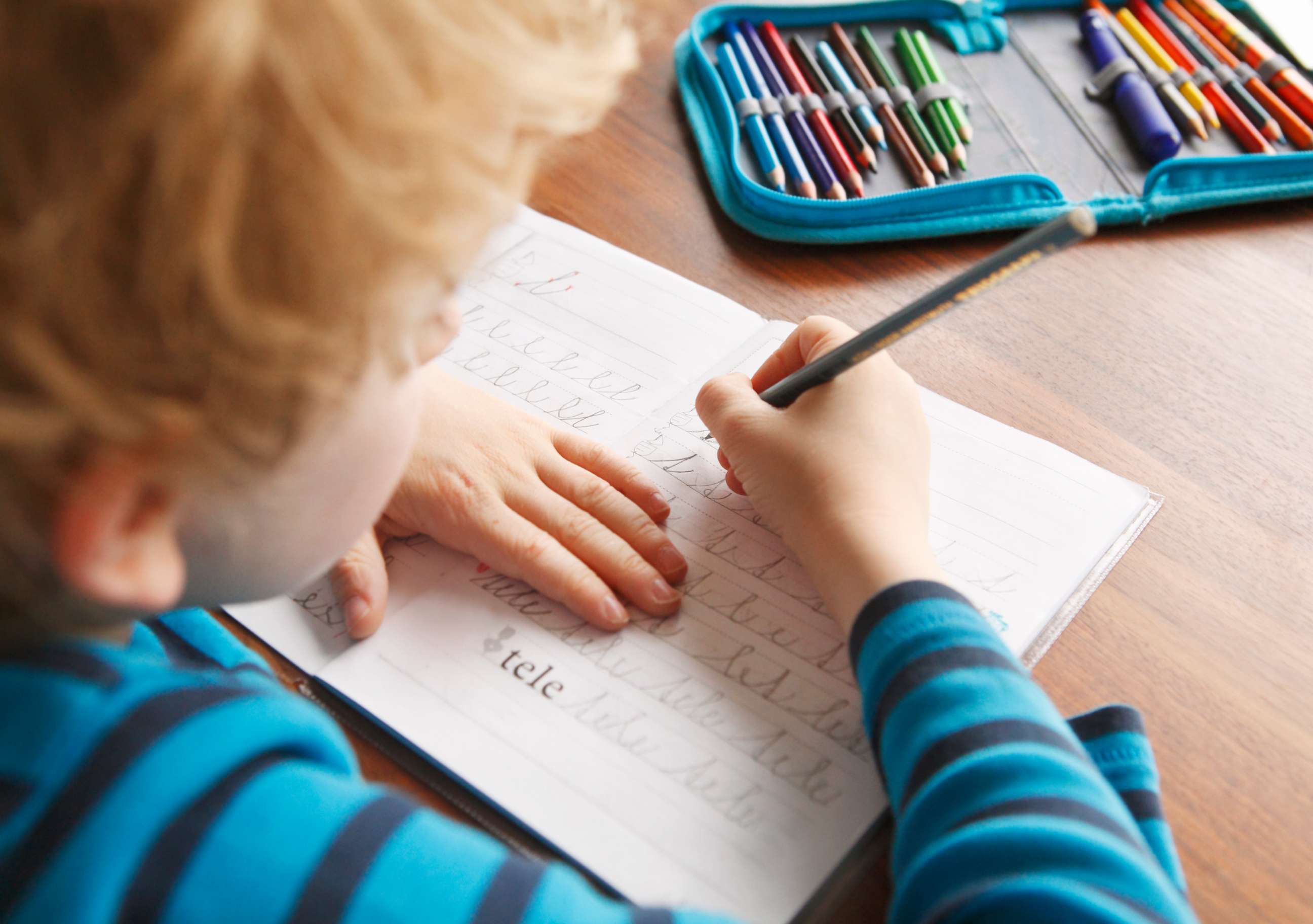 PHOTO: A boy appears to learn to write in cursive in this stock photo.