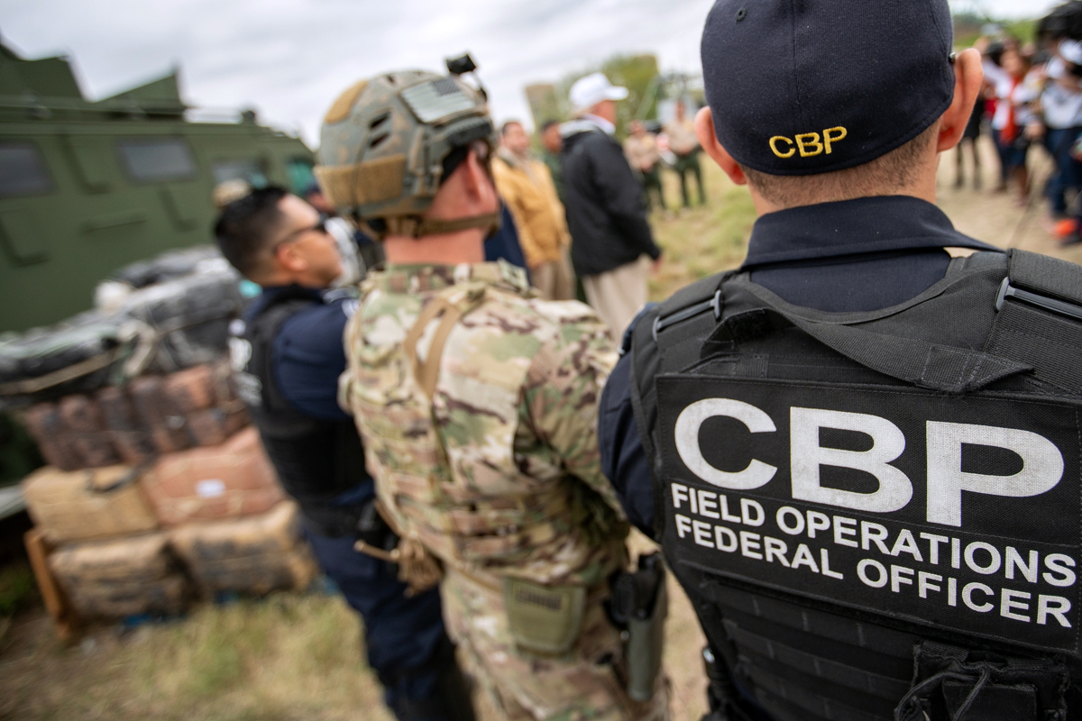 PHOTO: U.S. Customs and Border Protection officers listen to President Donald Trump near the U.S. Border Patrol McAllen Station in McAllen, Texas, Jan. 10, 2019.