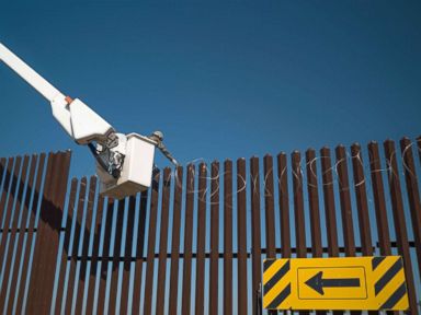 PHOTO: 541st Sapper Company Soldiers use a cherry picker to install concertina wire along the top of the border fence in Donna, Texas, Dec. 1, 2018.